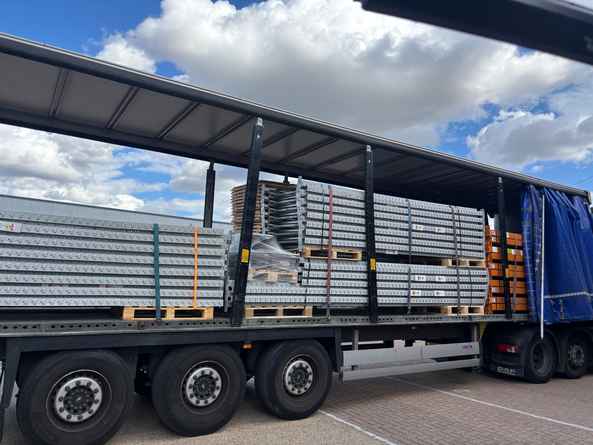 Racking Dismantling Walton-on-Thames - Strapped pallet racking beams and frames loaded on a curtain-sider trailer | UM Storage Systems
