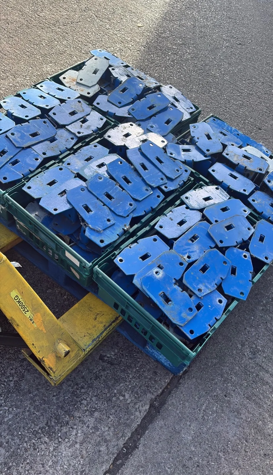 Racking Components UK - Blue racking baseplates gathered into crates | UM Storage Systems