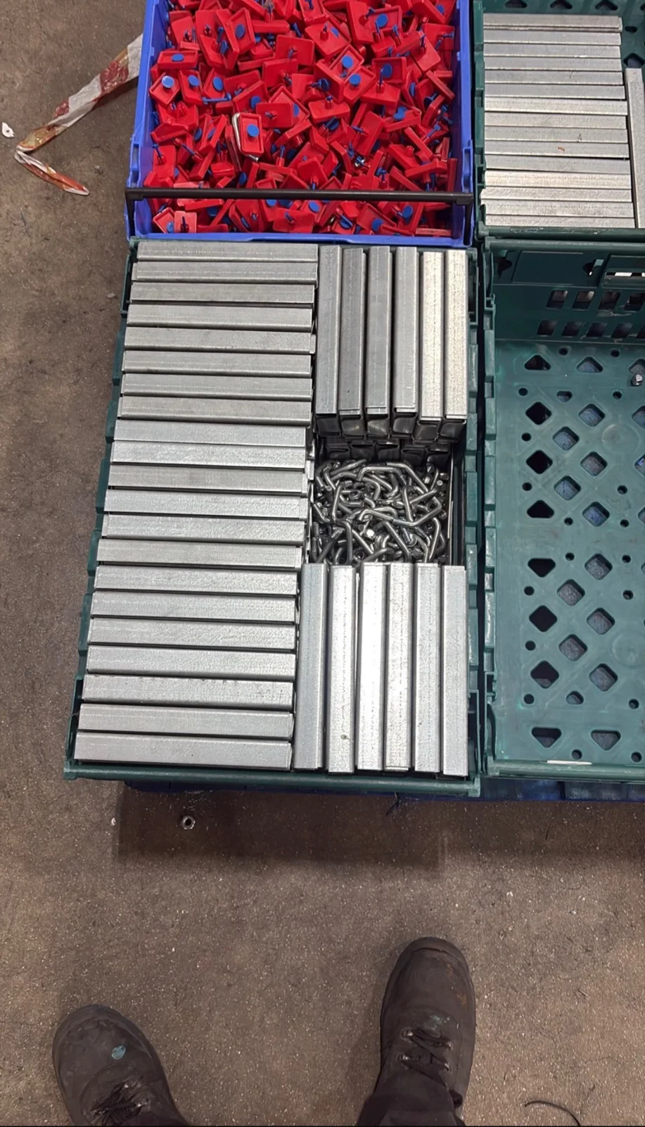 Racking Components UK - Metal spacers, fixings and red clips sorted into crates | UM Storage Systems