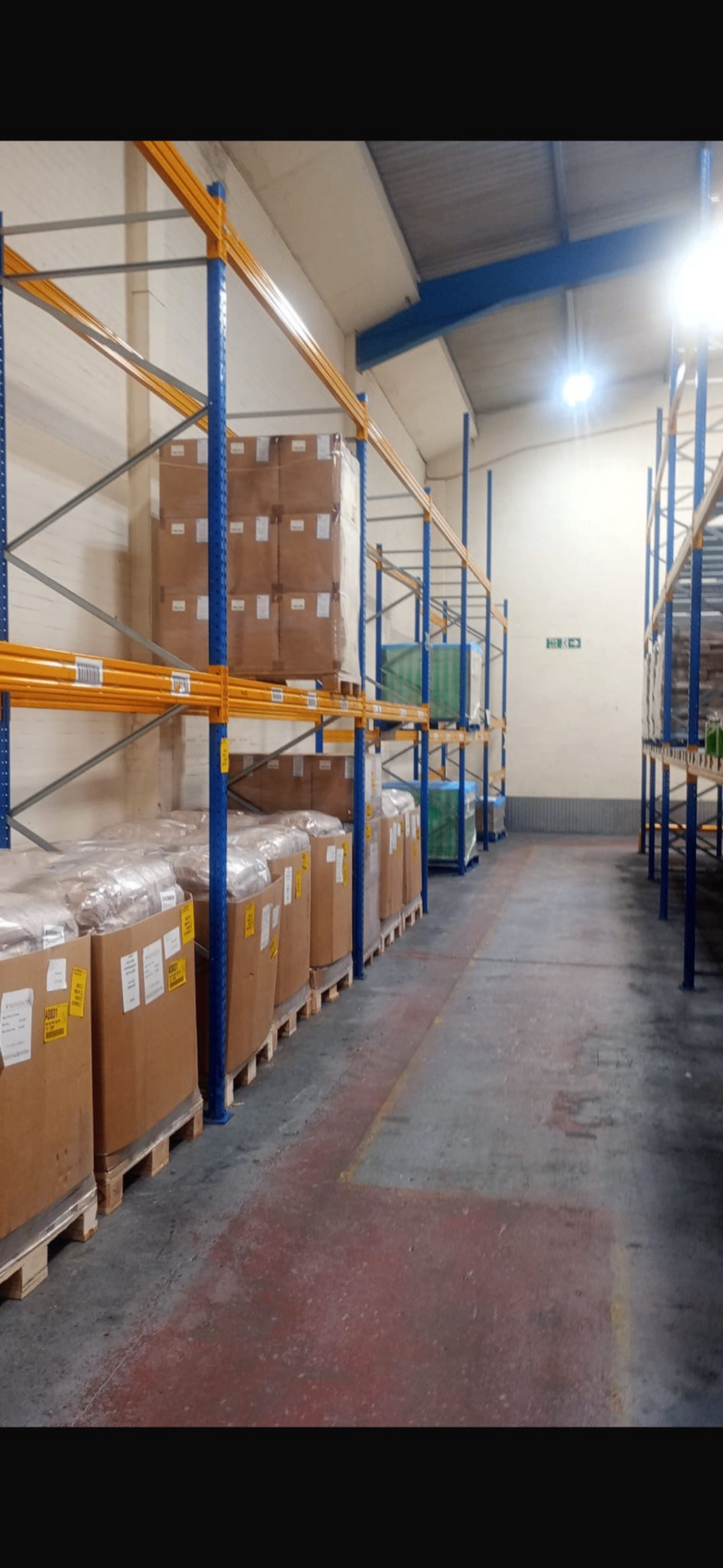 Used Pallet Racking For Sale UK - Esmena blue uprights and orange beams with palletised stock | UM Storage Systems