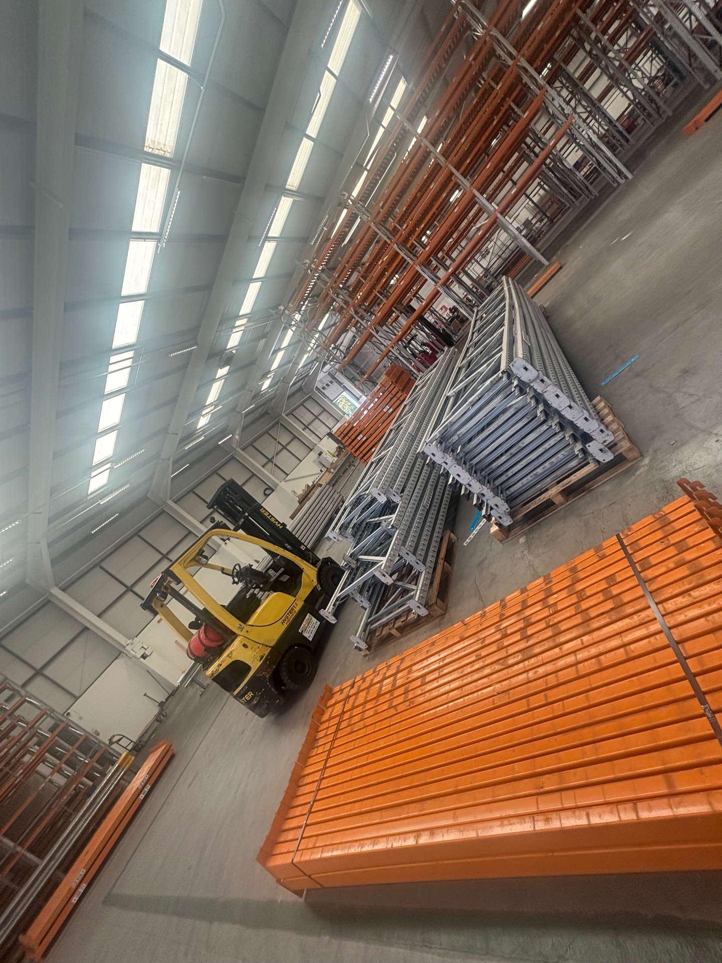 New Pallet Racking Installation - Galvanised frames and orange beams staged for a warehouse fit-out | UM Storage Systems