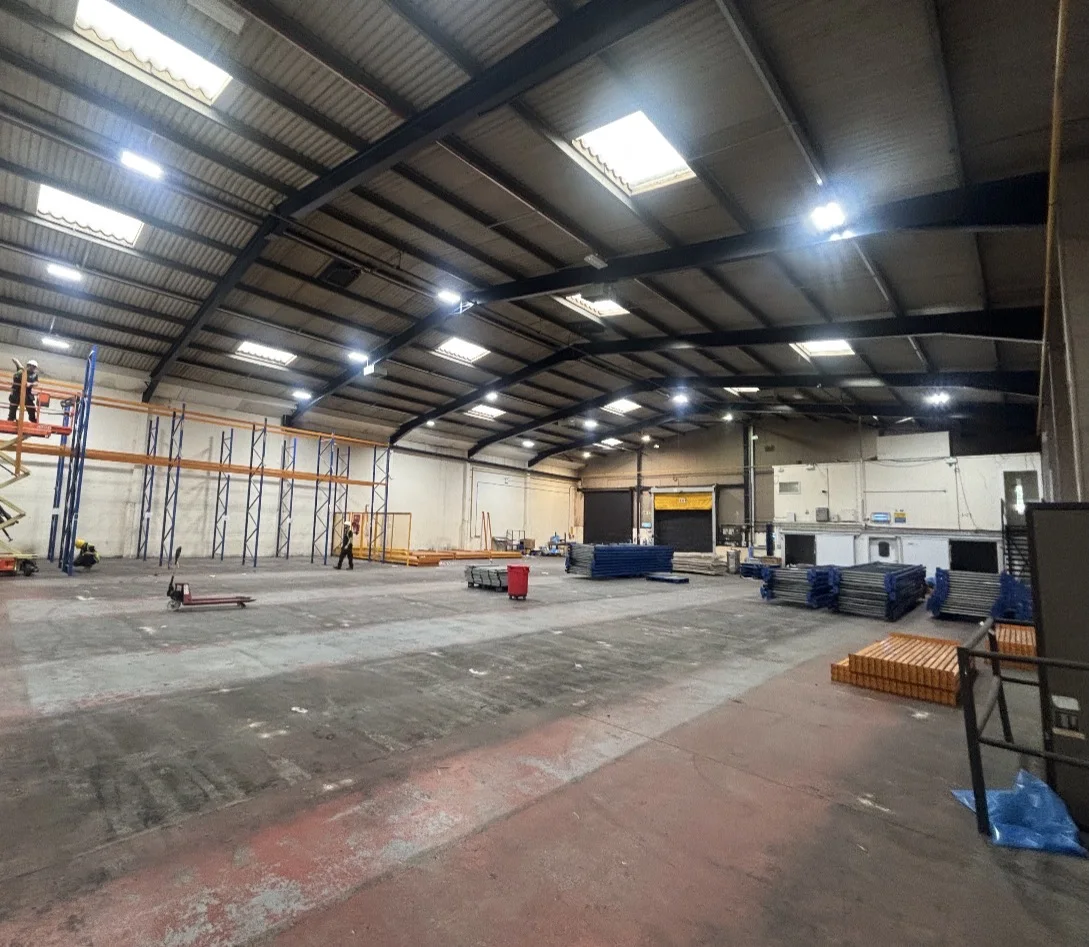 Warehouse Racking UK - Racking work in progress with blue frames and orange beams | UM Storage Systems