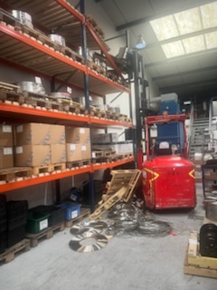 Emergency Pallet Racking Repairs UK - UM Storage Systems engineer on site with forklift assessing damaged warehouse racking | UM Storage Systems