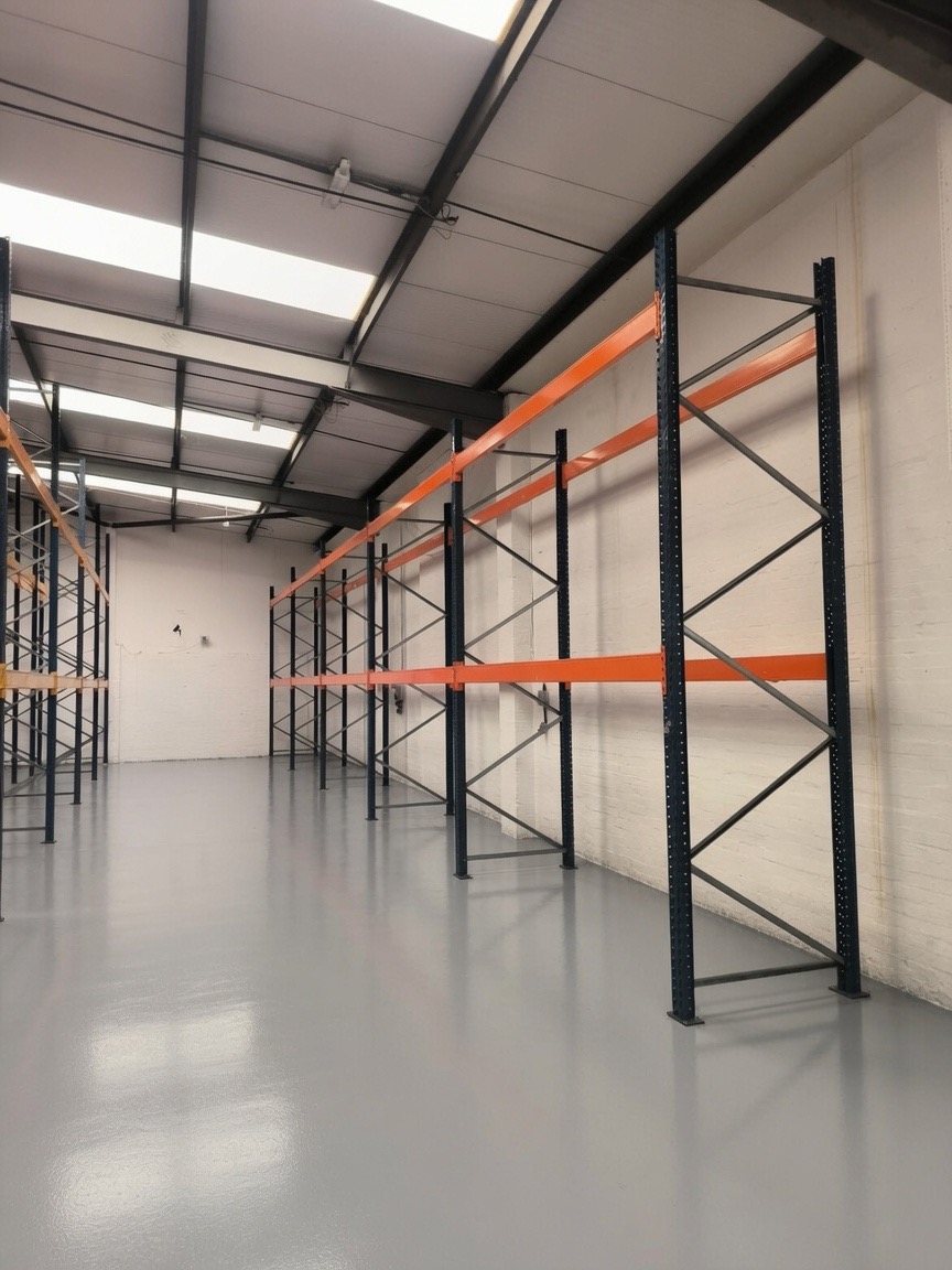 Pallet Racking Installation Midlands - Blue uprights and orange beams in a newly fitted warehouse | UM Storage Systems